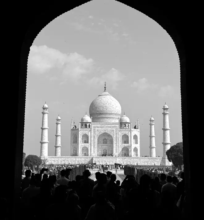 The Taj Mahal framed by a dark archway